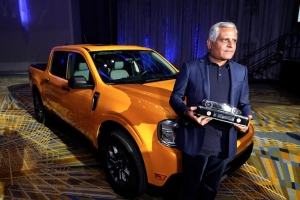 Kumar Galhotra who leads Ford Blue, poses at last years award show with the Truck of the Year,  the Ford Maverick. 